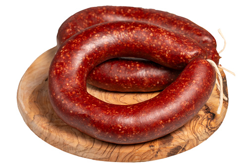 Ring sausage in beef rounds casing on wooden board