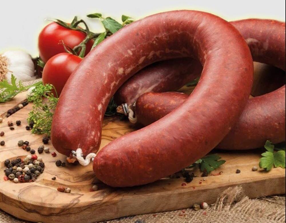 Ring bologna in beef casings with spices on cutting board