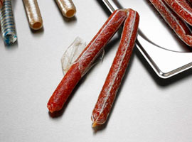 Dry-cured snack sticks in cellulose casing