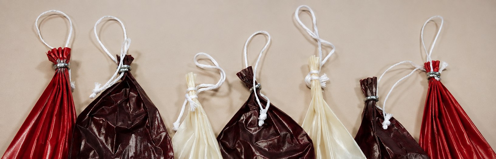 Clipped fibrous casings hanging, ready to stuff