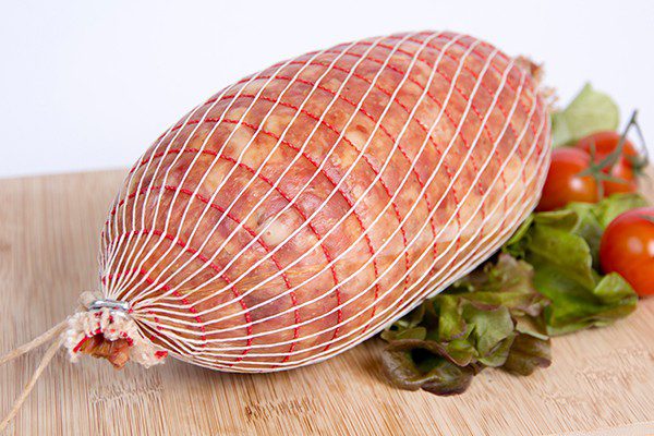 Red accent netting on smoked ham