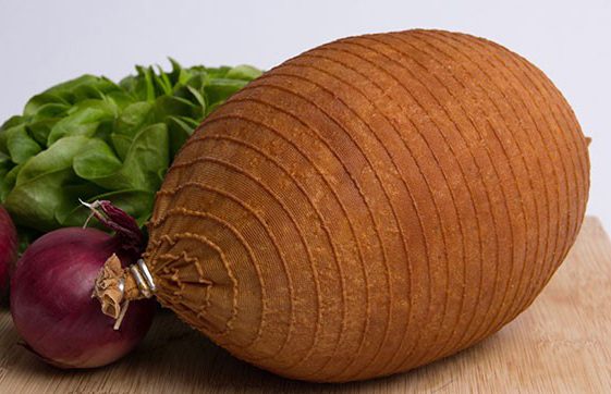 Stocking net on smoked ham showing rustic horizontal pattern