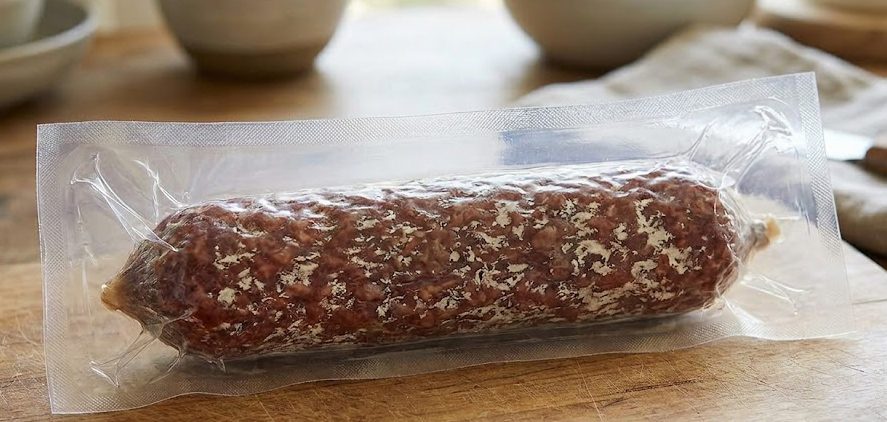 Salami log vacuum packaged in clear pouch