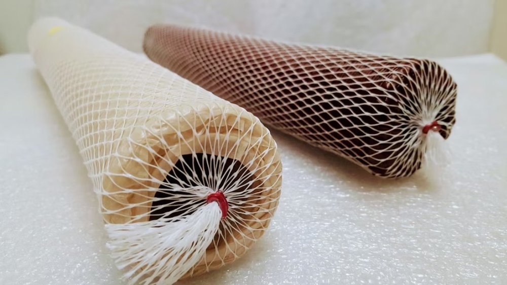 Shirred fibrous casings in netting, clear and mahogany